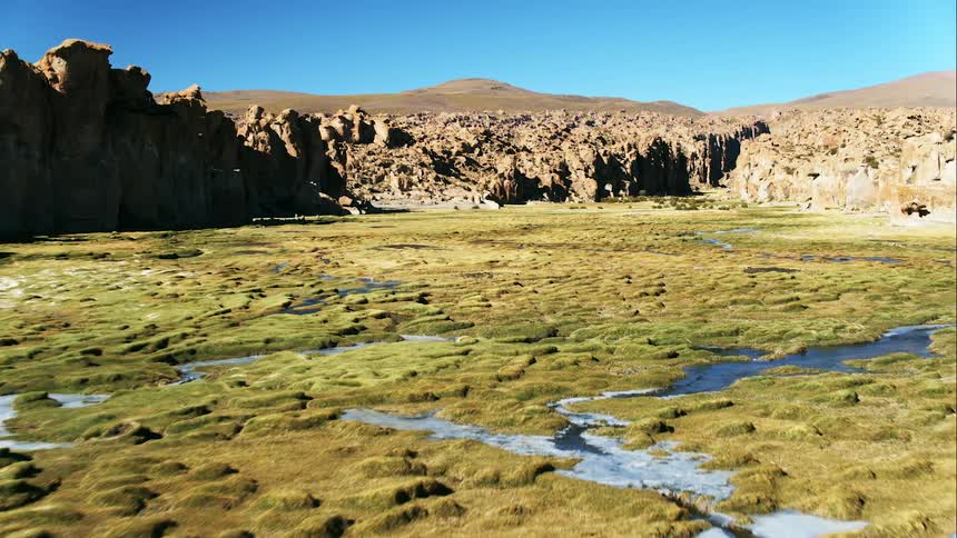 An aerial view of water surrounded by cliffs