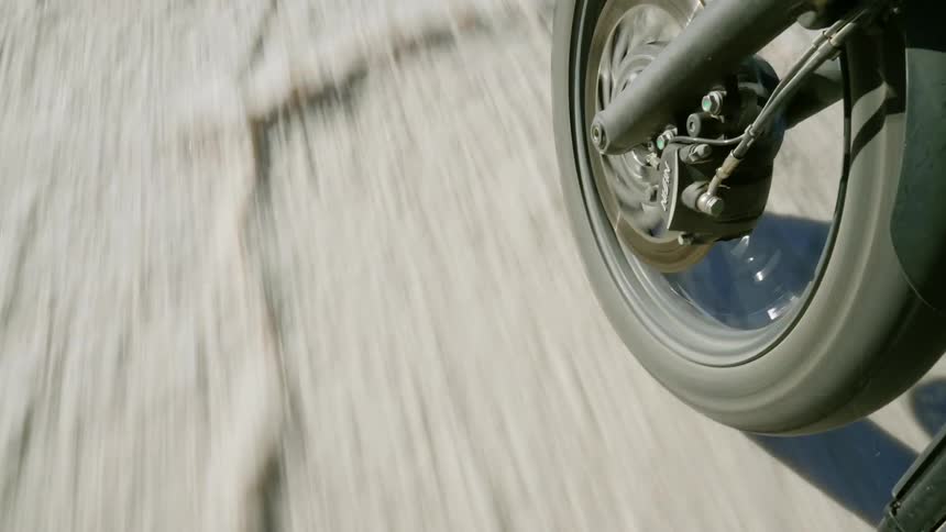 Close up of motorcycle wheel as it is being driven
