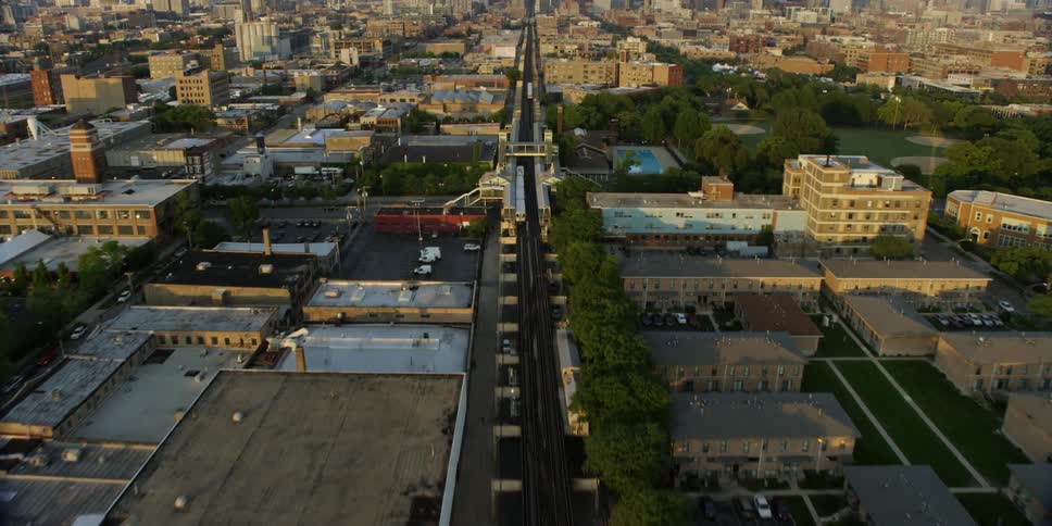 Moving fast over a train track going towards a city