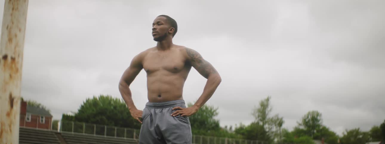 A man is stretching outside in the park