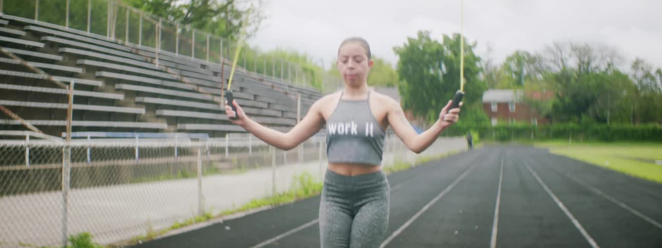Woman jumping rope on track