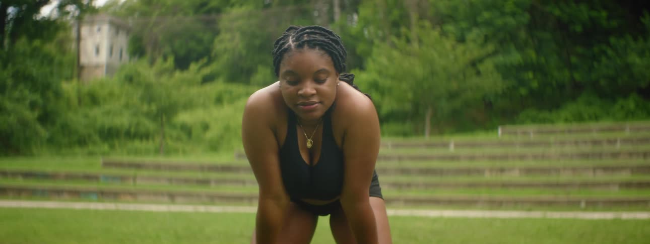 A woman rests in the park after exercising
