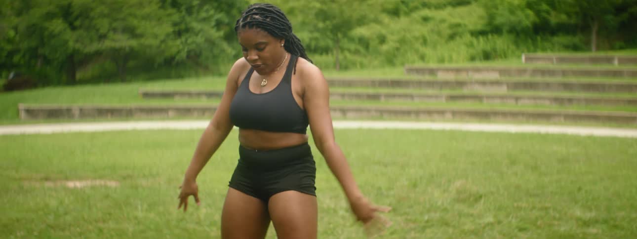 A woman is exercising with a medicine ball