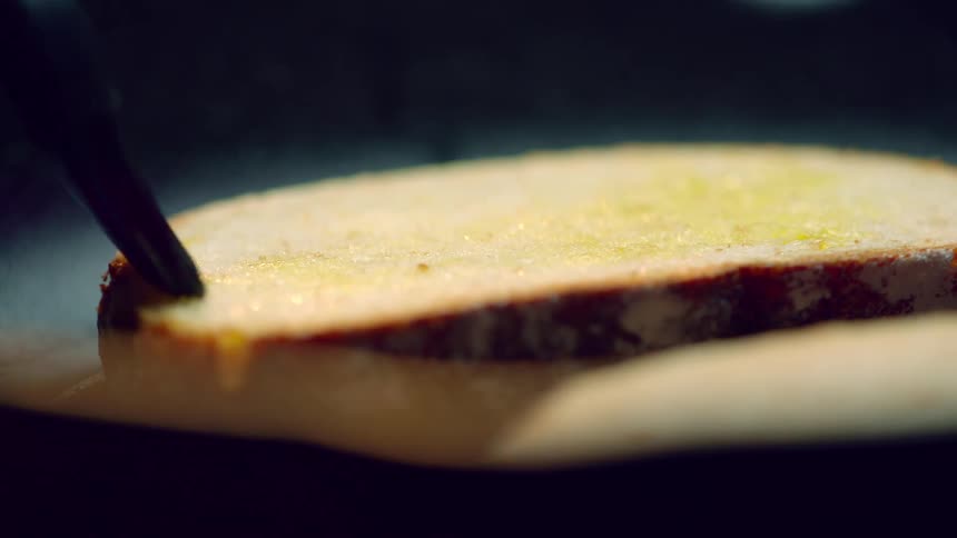 A person basting bread with a brush