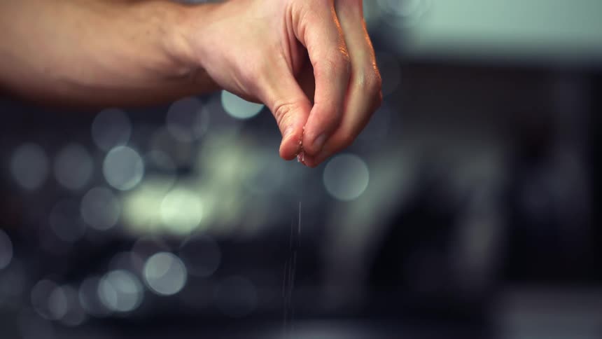 A person is sprinkling salt
