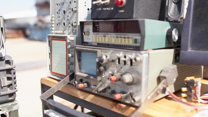 Scientific machines are stacked on each other on wooden table
