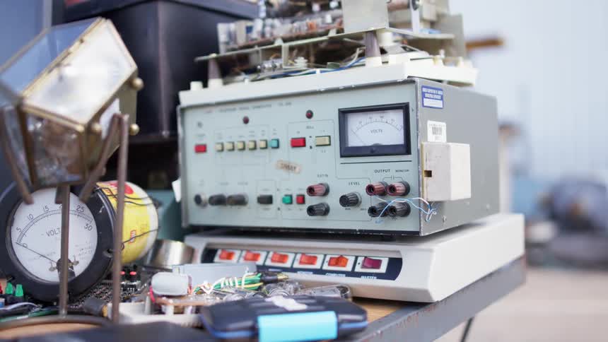 A large machine with many buttons is on the table outside