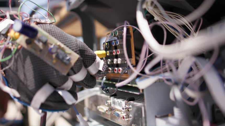 A person plugs a wire into the machine
