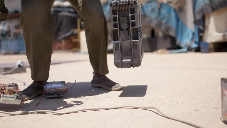 A person picks up a computer case and walks off
