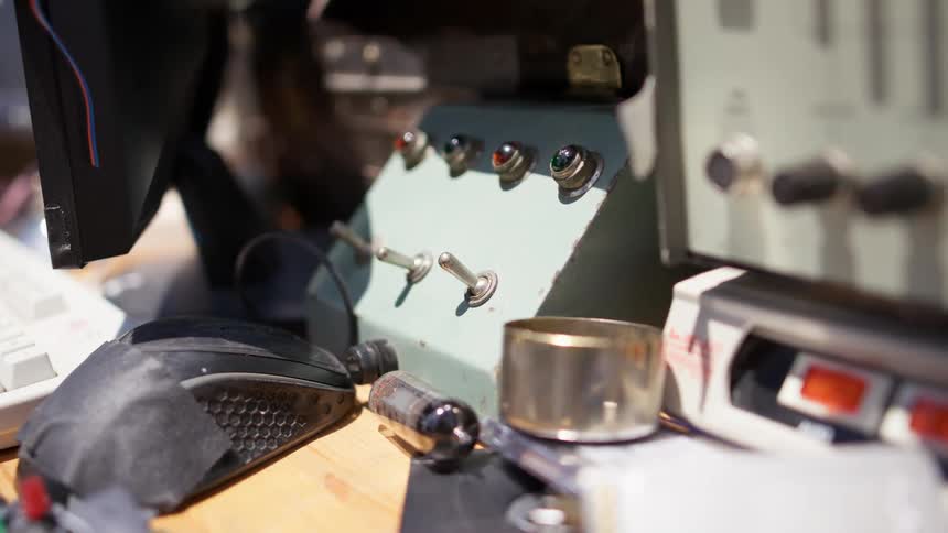 A dispatcher flips a switch on a device next to his computer