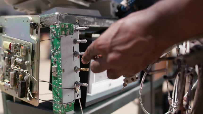 A man turning dials on machinery