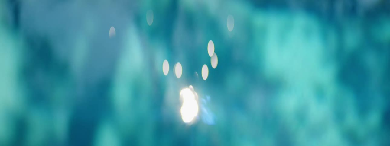 White lights glint and shine against blues and whites