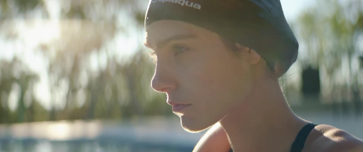 A girl is in the pool on a sunny day