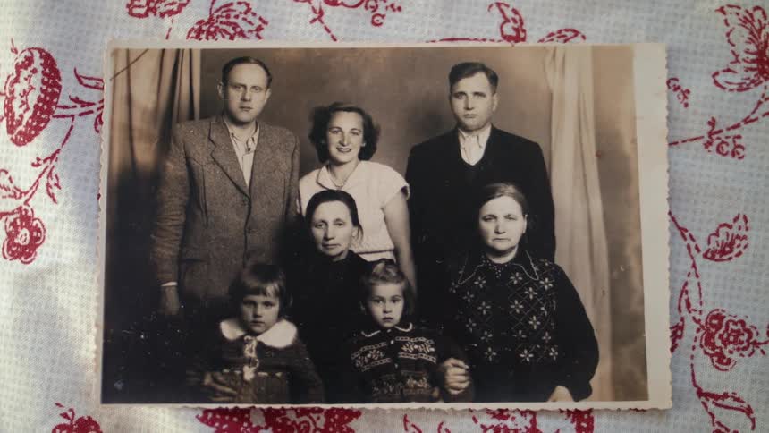 An old black and white photo is of a family