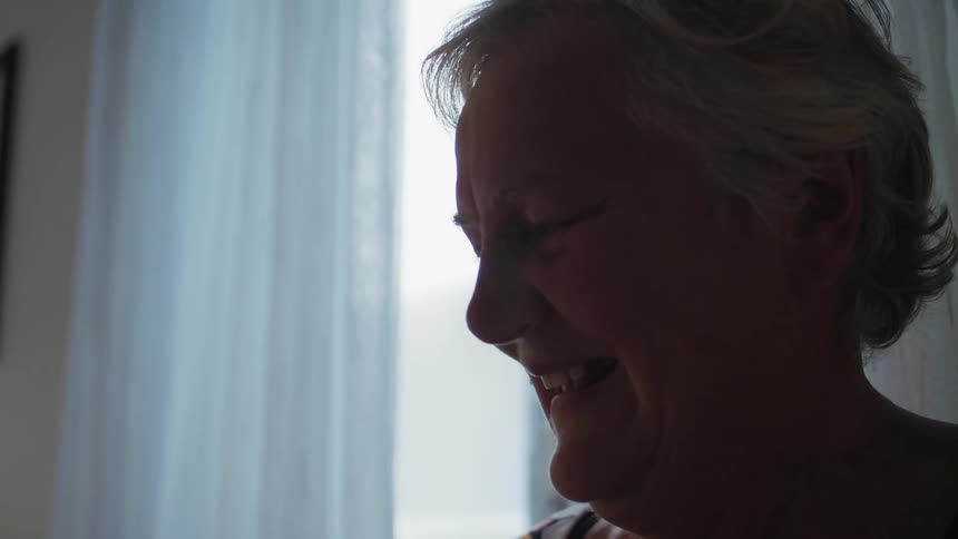Older woman smiling and talking