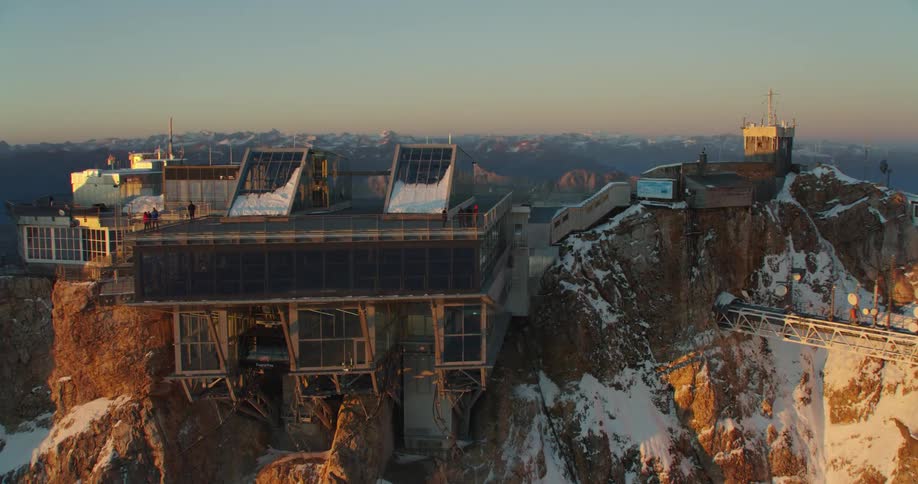 A large refinery sits on top of a mountain