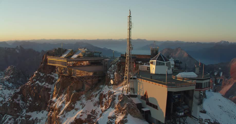 Large building on top of a snow covered mountain