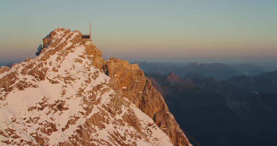 Observation building on tall mountain peak at dawn