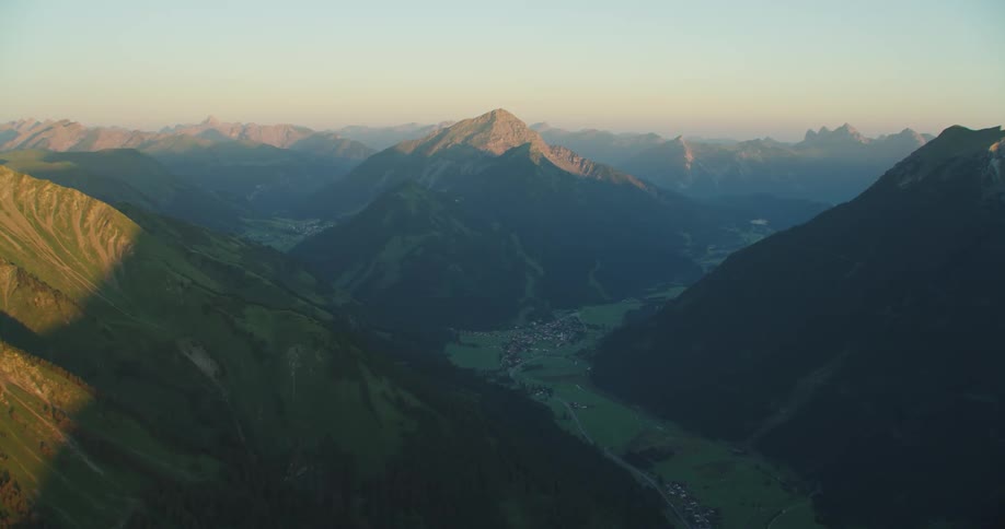 Aerial view of mountains at dusk is displayed