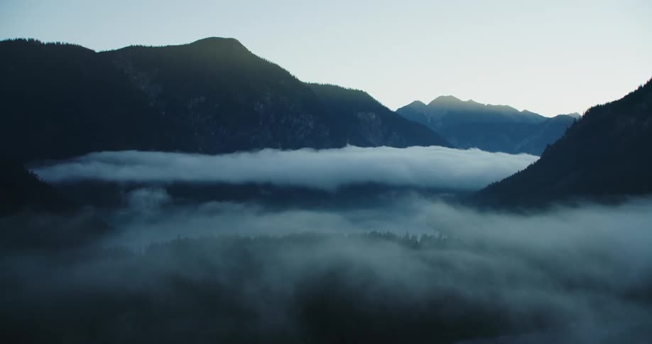 Heavy fog in valley between mountains