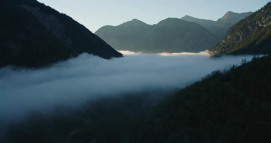 Fog is covering the mountains at dusk
