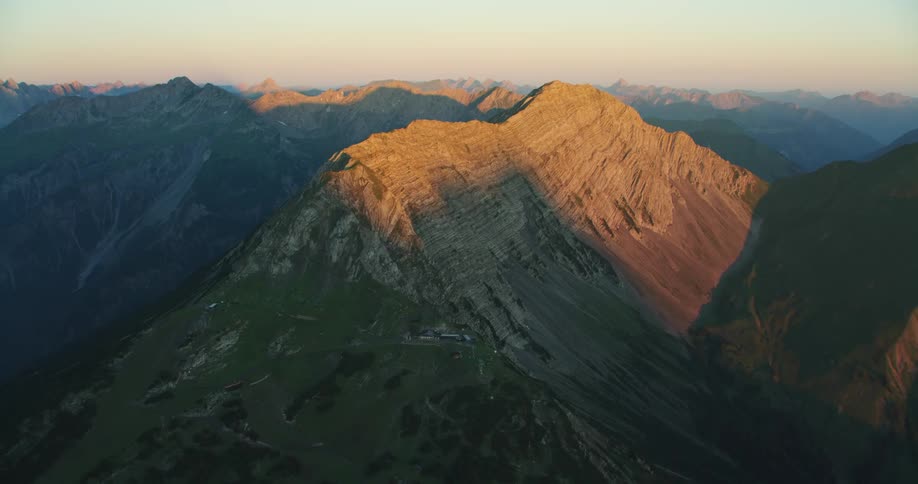 Vegetation covers the slope of a mountain range