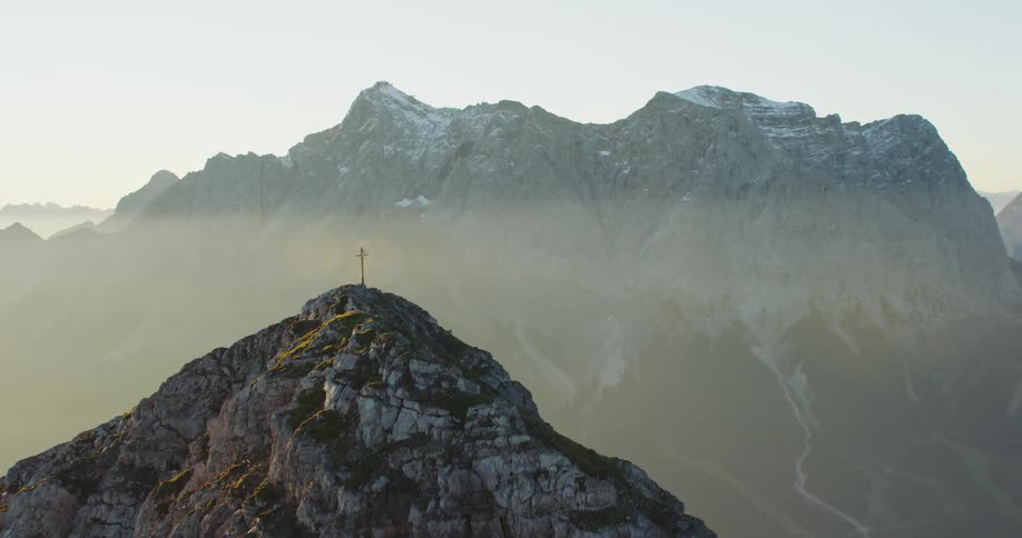 A vast foggy mountain valley between two mountain ridges on a sunny day