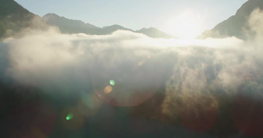 Low hanging clouds between mountains in river valley
