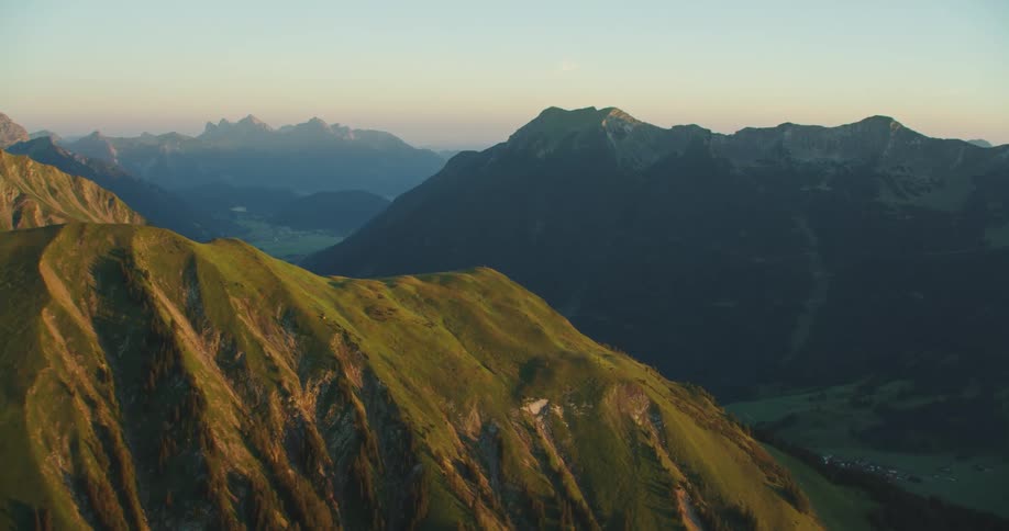 Mountain range with peaks and valleys near the sky and fog