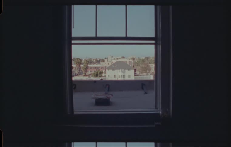 Town shows through window of dark room