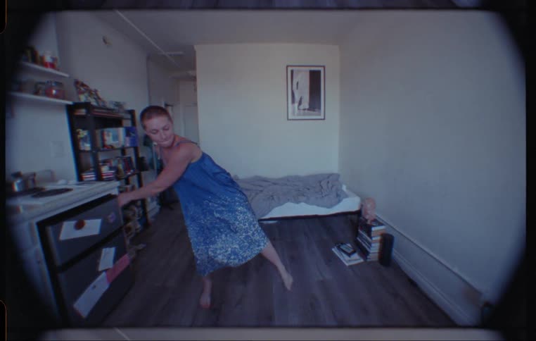 A woman twirling and dancing at home