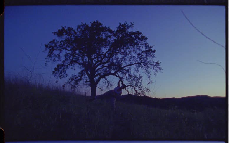 A young woman exercising outside on a hill