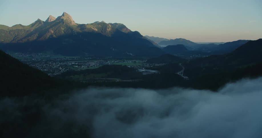 Aerial view of mountains is displayed at dusk