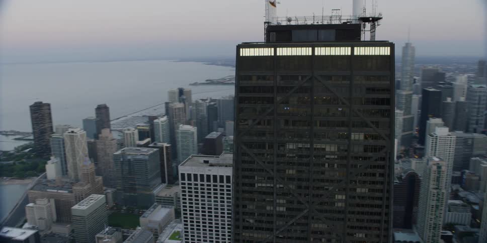 Aerial view of a tall dark building in a large city