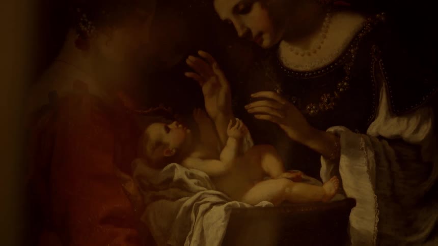 A painting hung on a wall of a mother and her child
