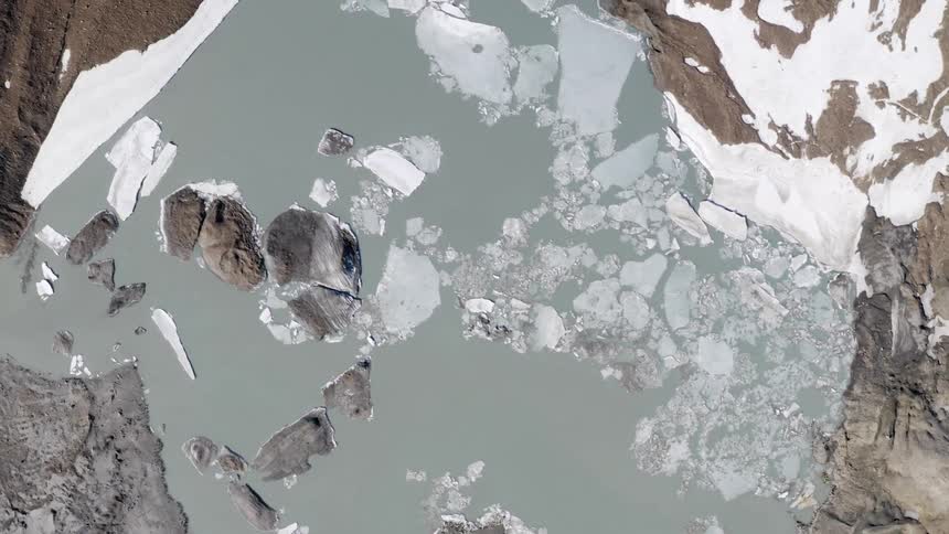Ice chunks are visible in a body of water