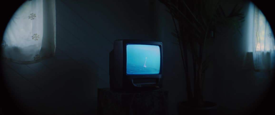 The small television is flickering in the room