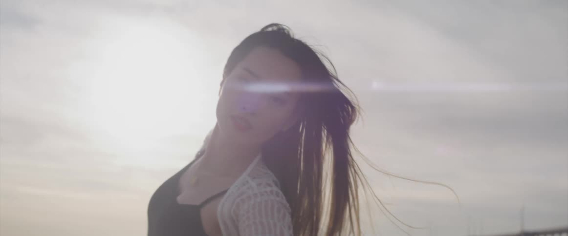 A young woman dancing on the beach