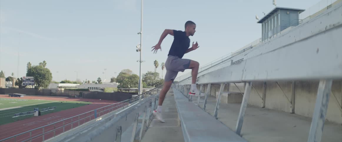 A man is jogging up a flight of stairs