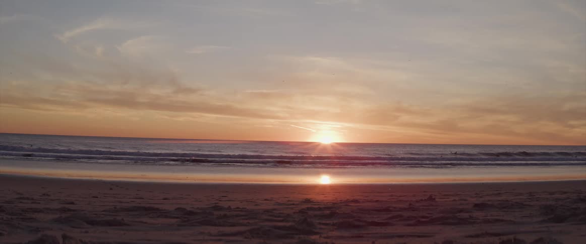 Waves rolling in to the shore as the sun rises