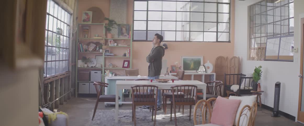 A young man pacing in a room at home