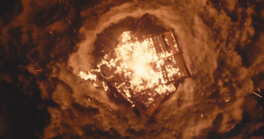 Overhead on a fire burning at night with sparks