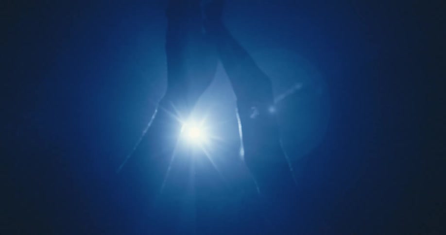 Hands clap in front of lights at a party