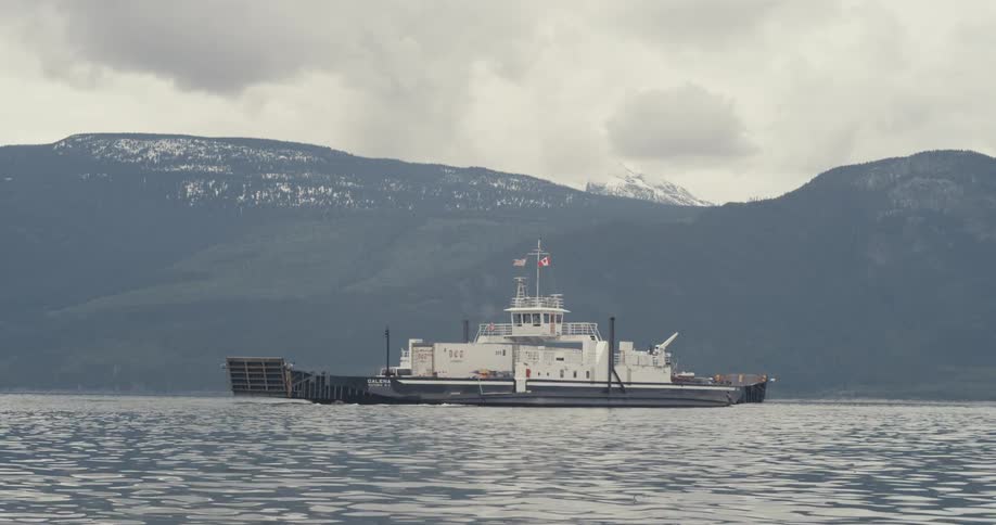 A ferry moves across a lake