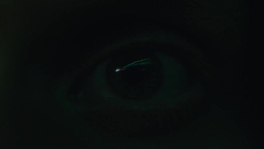 Lights strobe around an eyeball in the dark