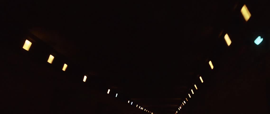 Lights illuminate a dark tunnel