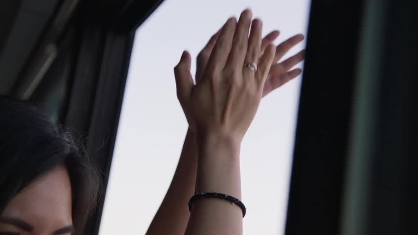A woman claps at the window