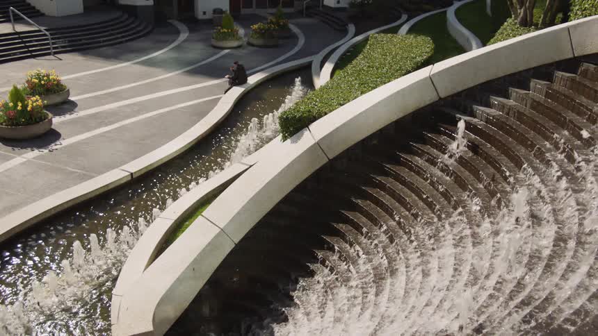 The fountain pours water down stairs