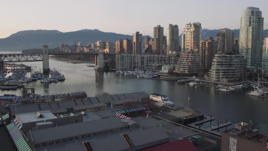 The buildings stand tall near the river
