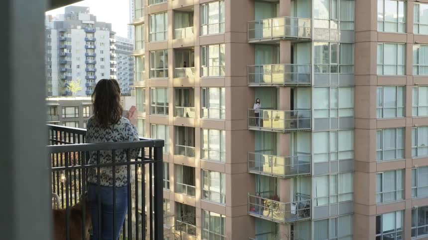 Neighbors clap their hands from balconies as they stays under lockdown